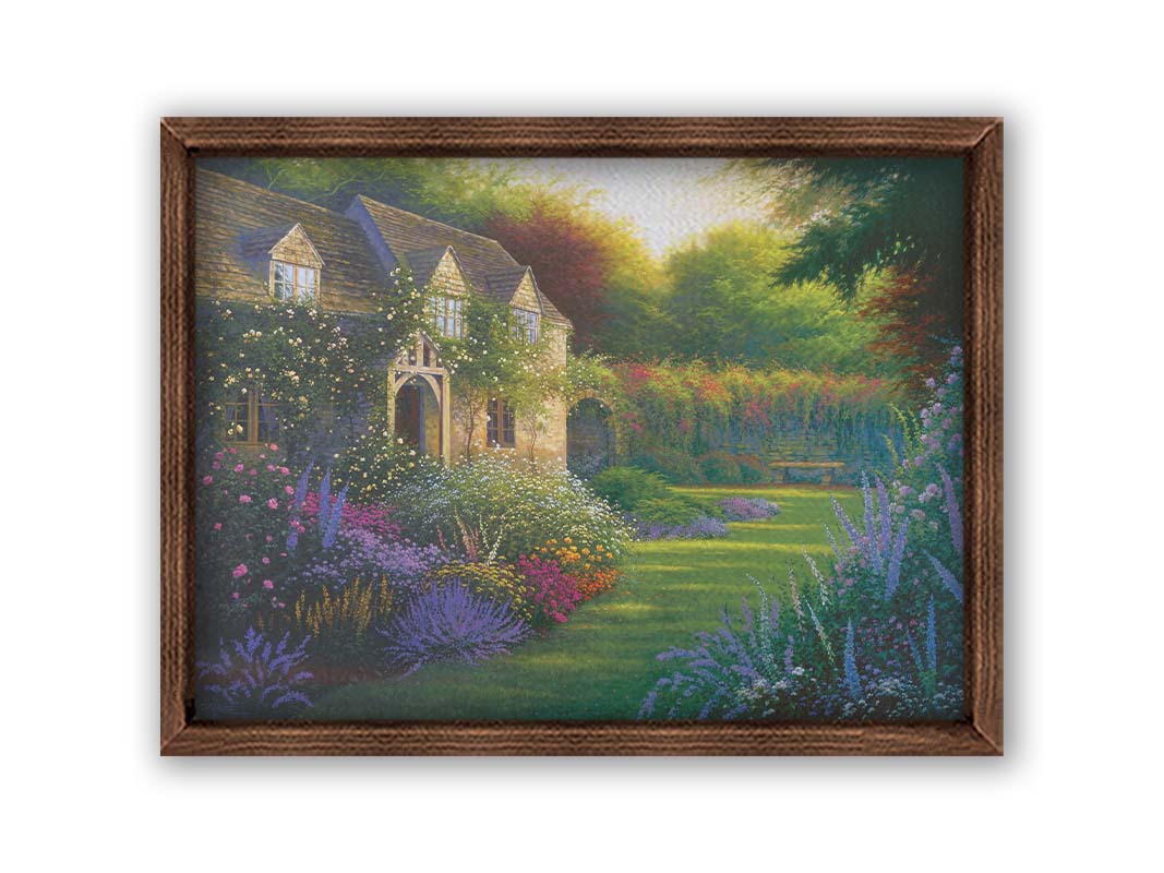 A painting of a blooming garden, with flowers in a variety of pinks, purples, yellows, and whites. A bench site in the grassy clearing beside a cottage, draped in white-flowered vines. Printed on canvas and framed.