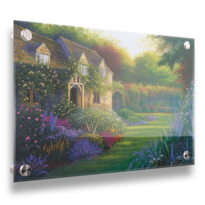 A painting of a blooming garden, with flowers in a variety of pinks, purples, yellows, and whites. A bench site in the grassy clearing beside a cottage, draped in white-flowered vines. Printed on acrylic.