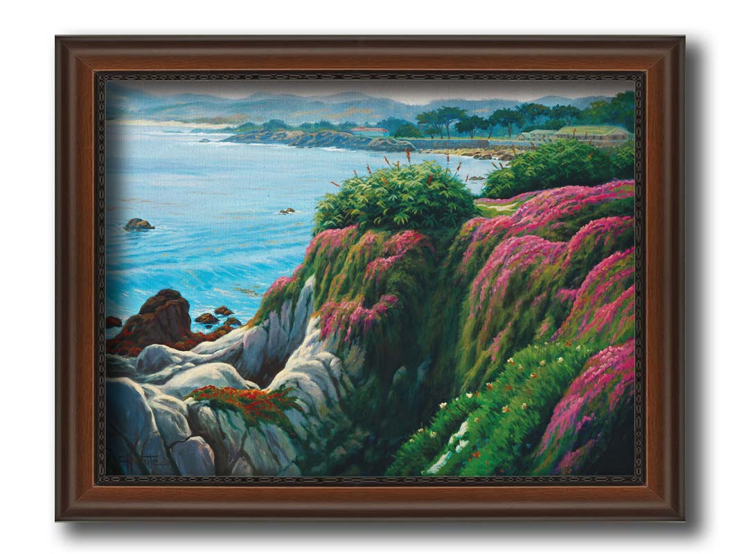 A painting of a clifftop covered in fresh green plants, sprouting pink flowers. Below, the bright blue ocean is calm. Printed on canvas and framed.