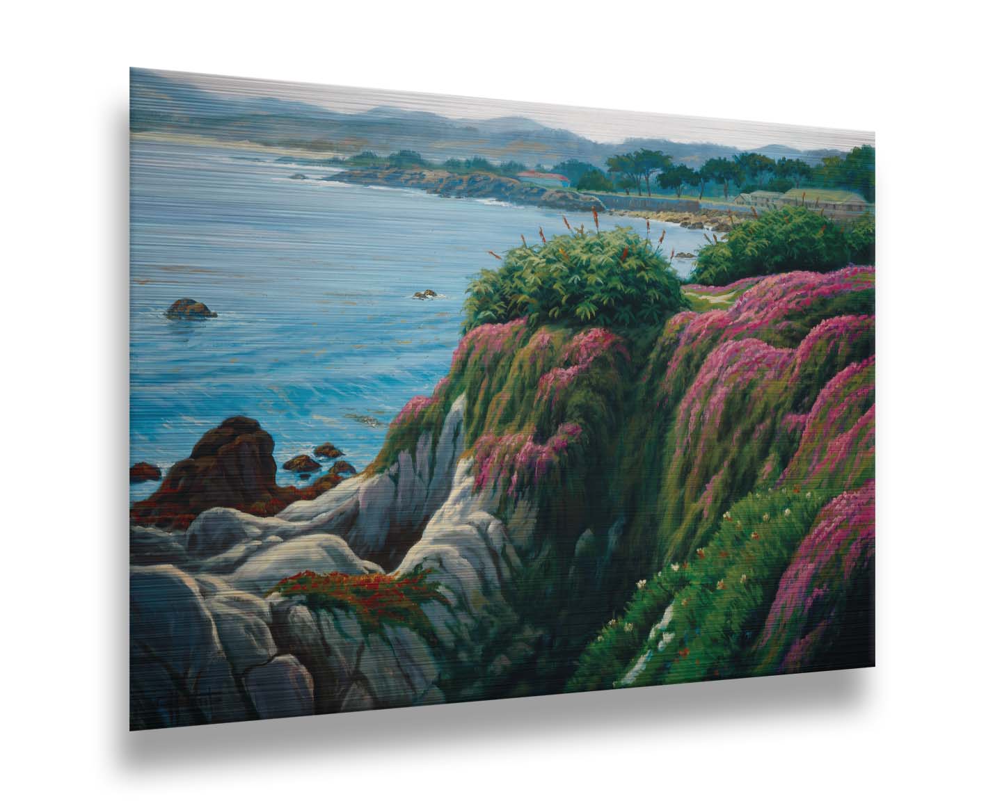 A painting of a clifftop covered in fresh green plants, sprouting pink flowers. Below, the bright blue ocean is calm. Printed on metal.