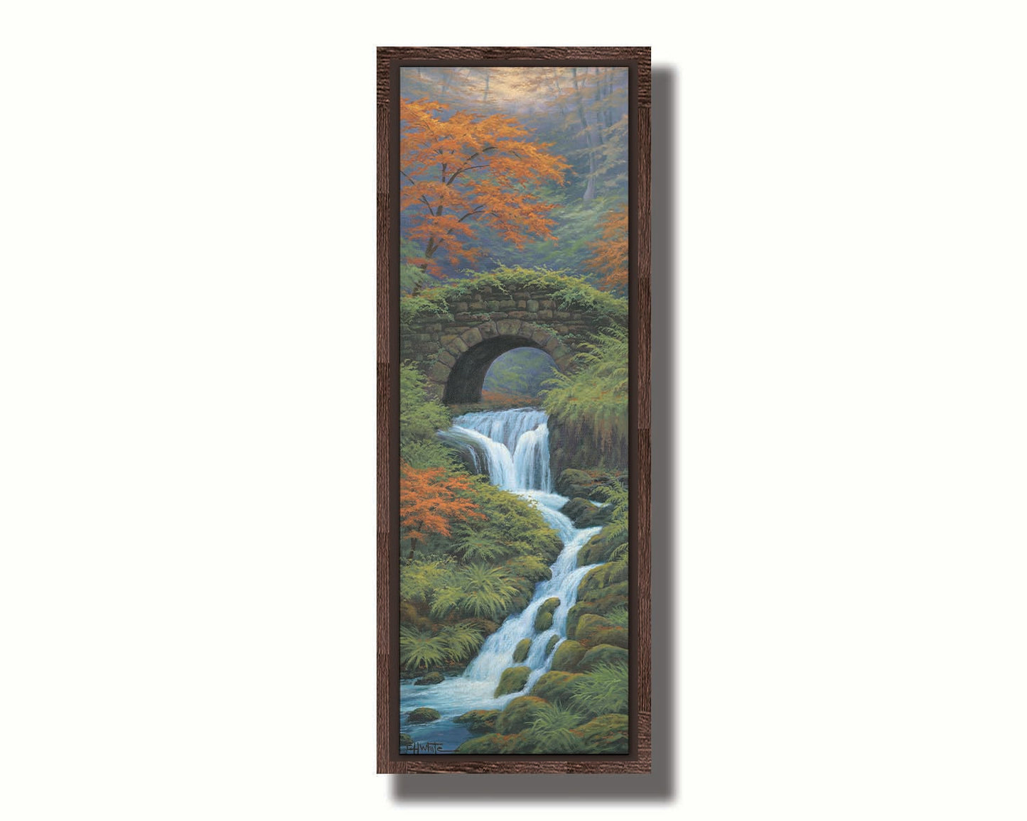 A painting of a creek waterfall, running through a forest. A stone bridge arches over the water. Printed on canvas in a float frame.