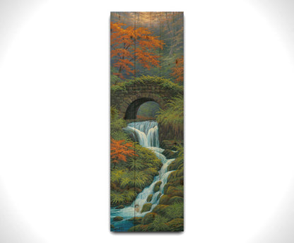 A painting of a creek waterfall, running through a forest. A stone bridge arches over the water. Printed on a wood pallet.