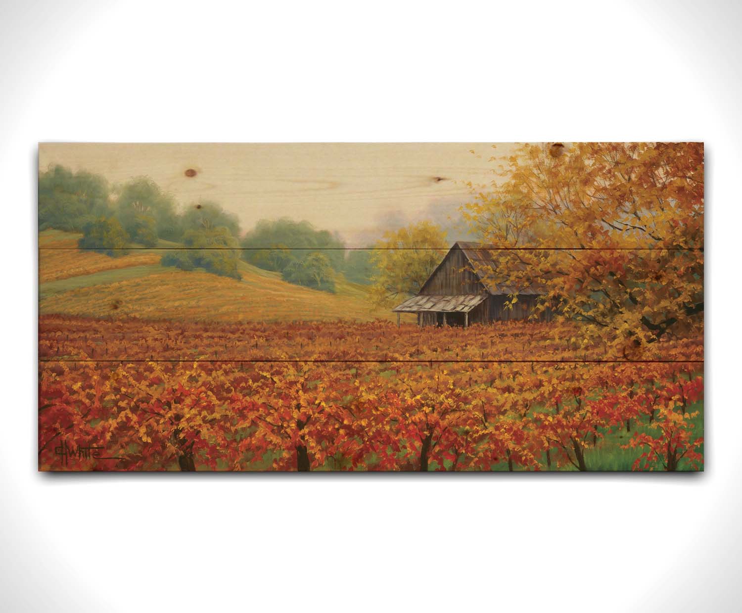 A painting of an old building amidst hills of red, orange, and yellow winery fields Napa Valley is known for. A fog obscures the trees in the distance. Printed on a wood pallet.