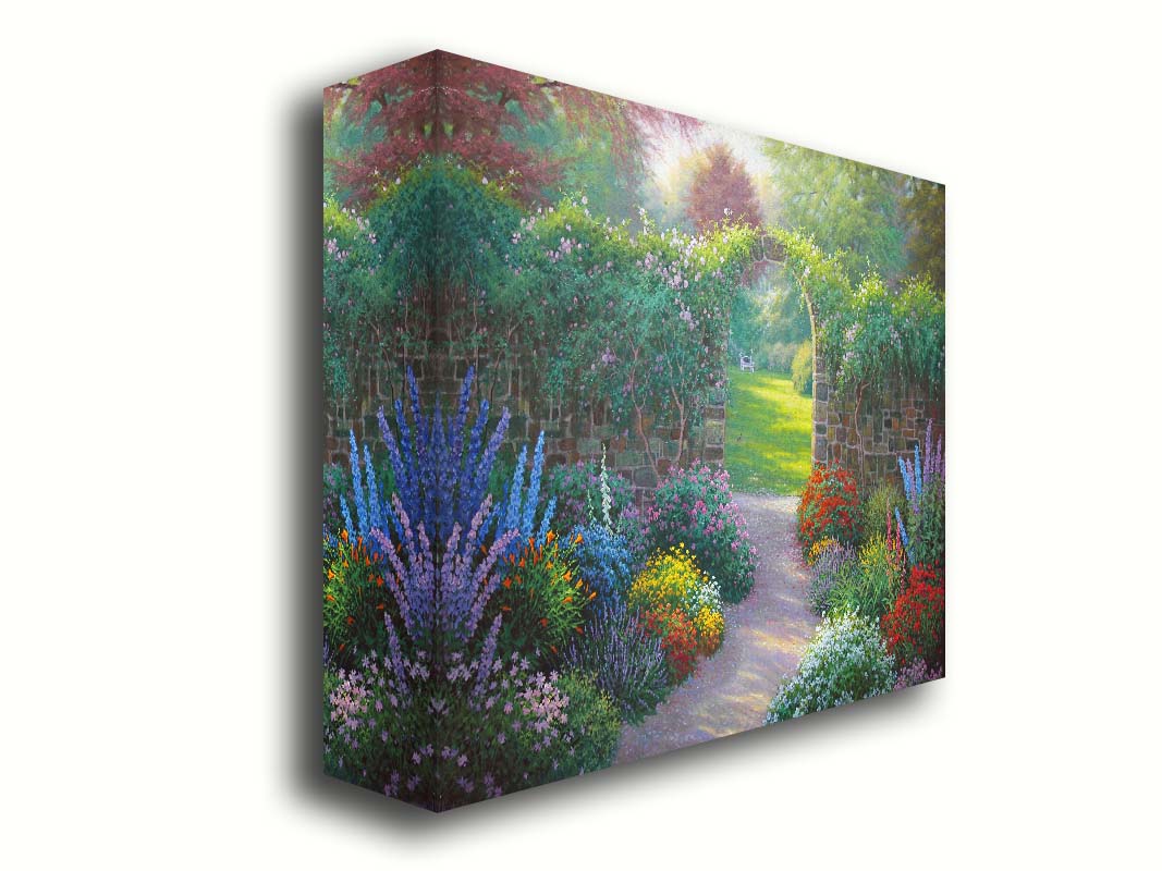 A painting of a stone walled garden with an archway leading to a grassy yard. There are flowers in all colors lining the pathway. Printed on canvas.