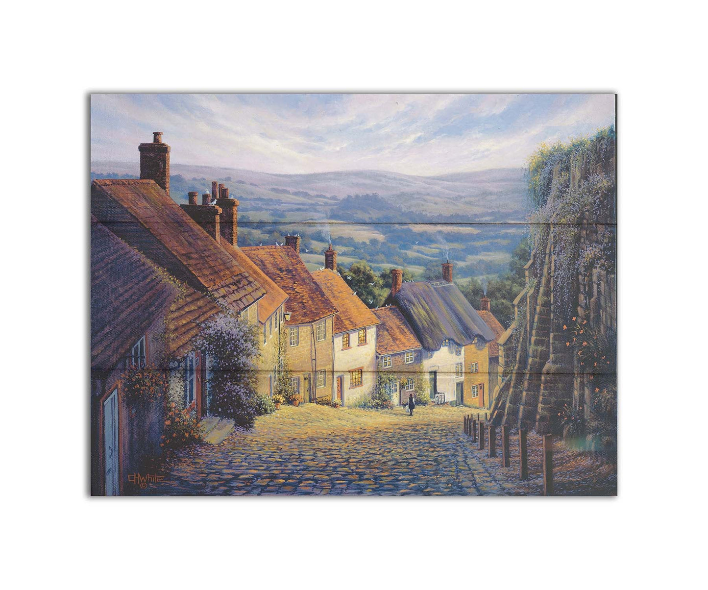 A painting looking down a cobblestone road on a hill lined with houses. A person can be seen walking down the path past flower-laden walls. Printed on a box board.