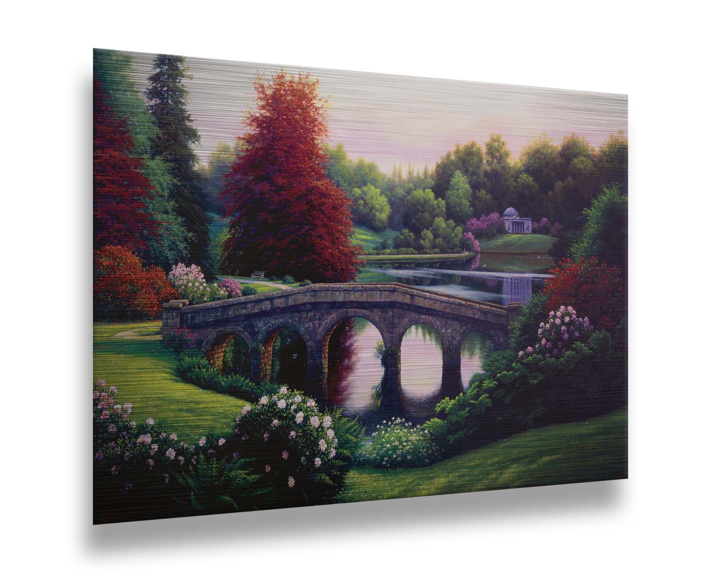 A landscape painting of a lake scene. A stone bridge in the foreground is surrounded by bushes of pink and red flowers, as well as green and red trees. Printed on metal.