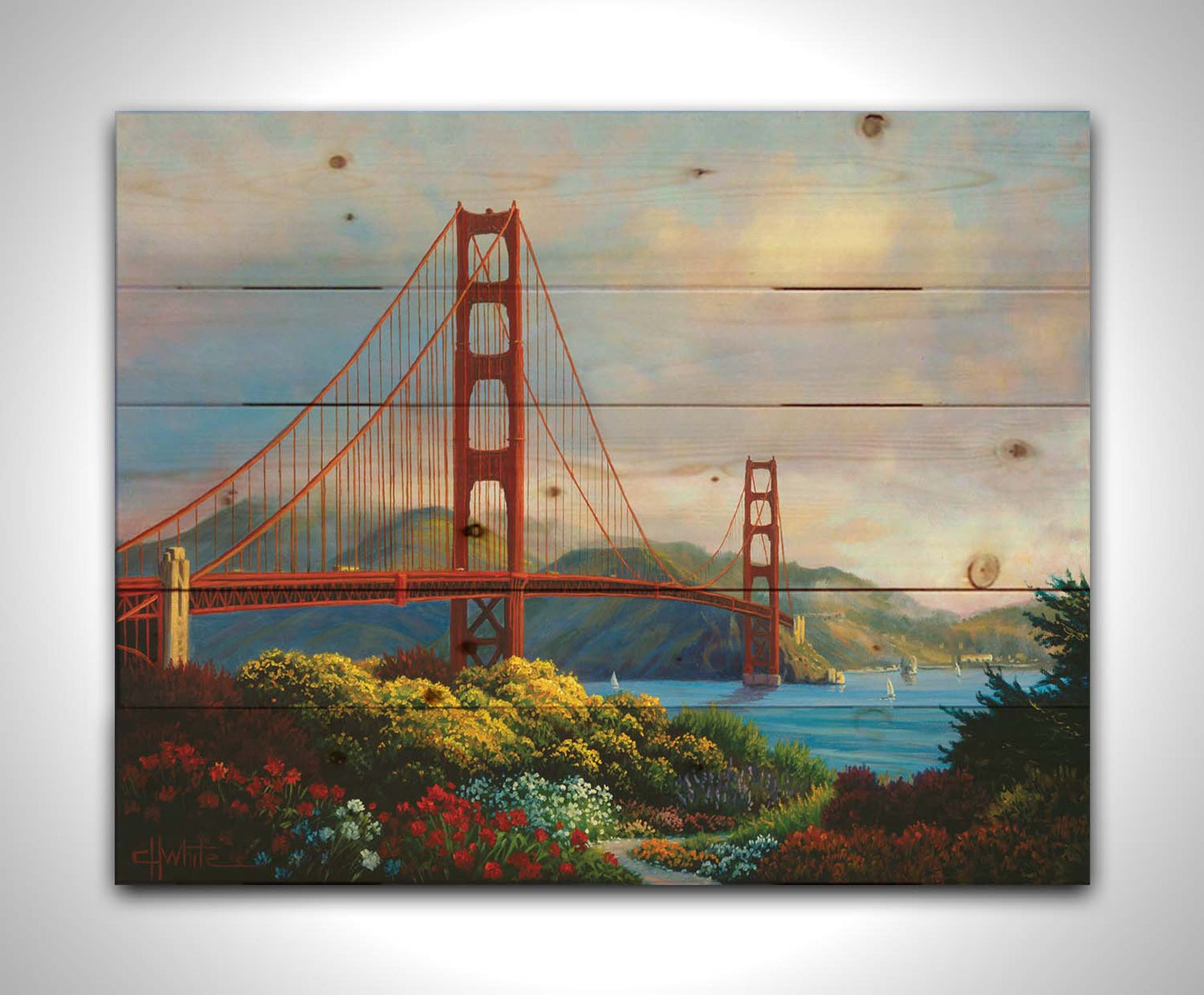 A painting of San Fransisco's Golden Gate Bridge, as viewed from Vista Point. Flowers bloom along the path in the foreground, and Lime Point and the Needles rock formation can be seen in the distance. Sail boats float on the water. Printed on a wood pallet.