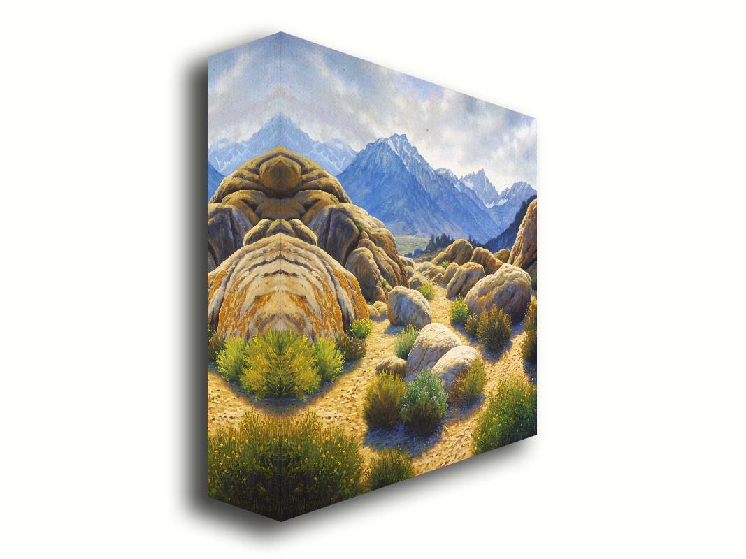 A landscape painting of Mount Whitney as seen from Lone Pine Lake, California. The highly detailed environment of tan stones directs the view to the distant mountains, tinted blue by the atmosphere. Printed on canvas.