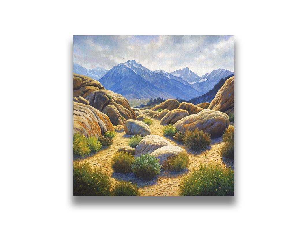 A landscape painting of Mount Whitney as seen from Lone Pine Lake, California. The highly detailed environment of tan stones directs the view to the distant mountains, tinted blue by the atmosphere. Printed on canvas.