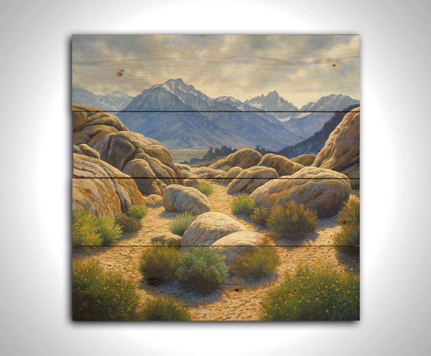 A landscape painting of Mount Whitney as seen from Lone Pine Lake, California. The highly detailed environment of tan stones directs the view to the distant mountains, tinted blue by the atmosphere. Printed on a wood pallet.