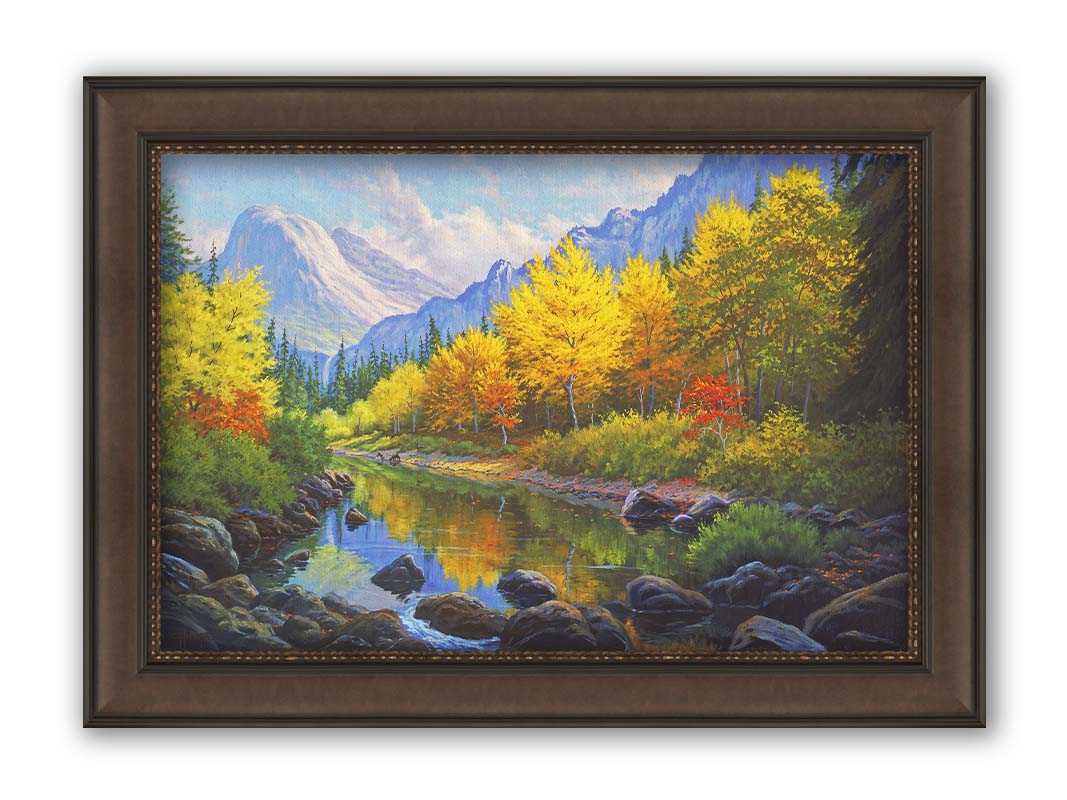 A painting of a forest in the mountains, with a stream running through it. The warm tones of the tree leaves are contrasted by the cool colors of the evergreens and blue mountains. Printed on canvas and framed.