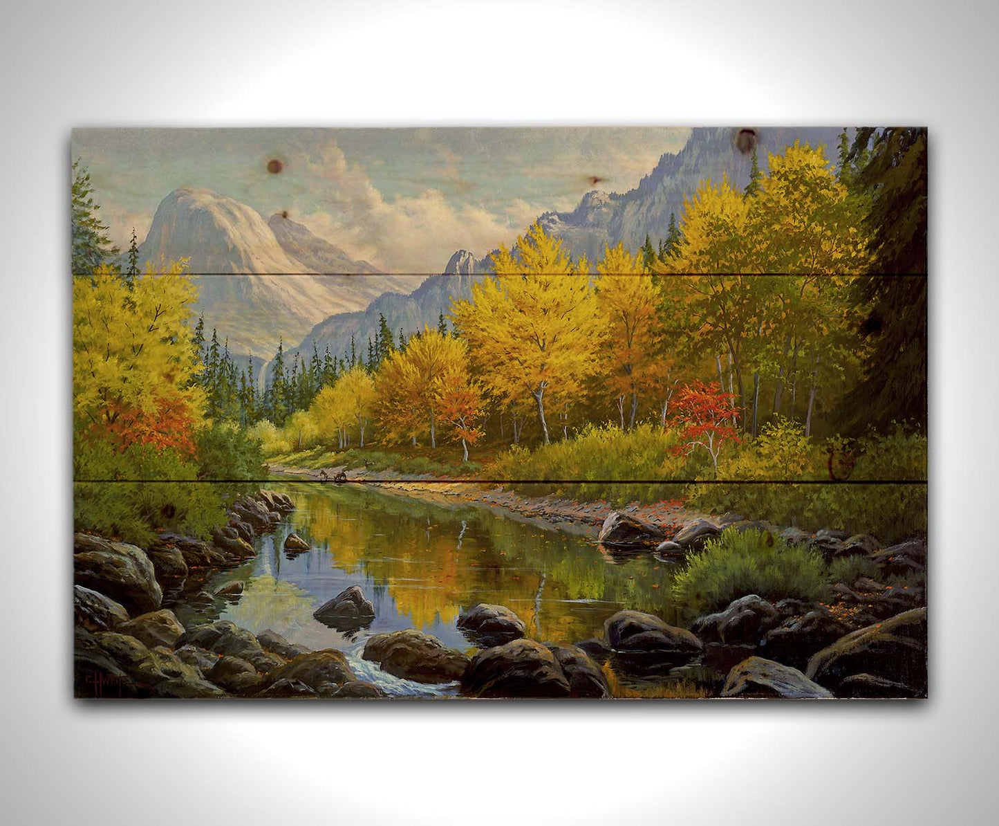 A painting of a forest in the mountains, with a stream running through it. The warm tones of the tree leaves are contrasted by the cool colors of the evergreens and blue mountains. Printed on a wood pallet.