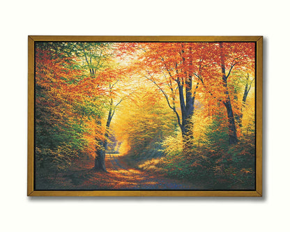 A painting of a path through an autumn forest, with sunlight highlighting the golden yellow and orange leaves of the trees. Printed on canvas in a float frame.