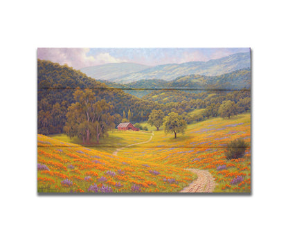 A painting of a grassy field of poppies and lupines on a hilly landscape. A path leads down to a red barn at the edge of a forest. Printed on a box board.