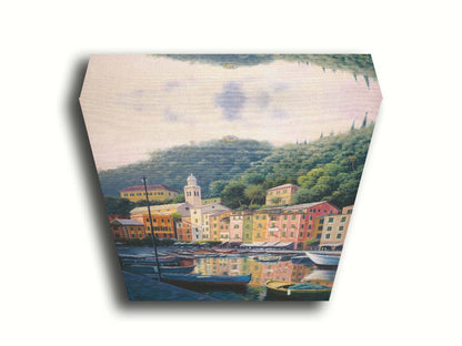 A painting of the colorful fishing town of Portofino. Many small boats are docked in the waters in the foreground, and the steep hills in the background are lush with trees. Printed on canvas.