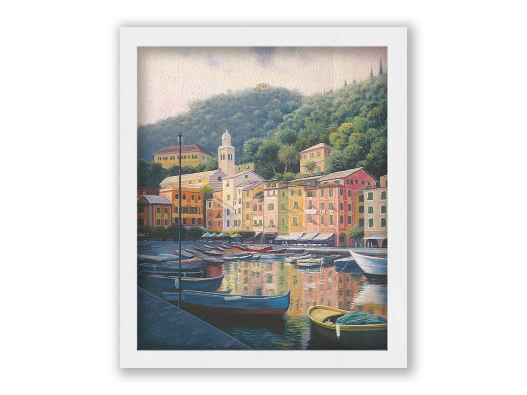 A painting of the colorful fishing town of Portofino. Many small boats are docked in the waters in the foreground, and the steep hills in the background are lush with trees. Printed on canvas and framed.