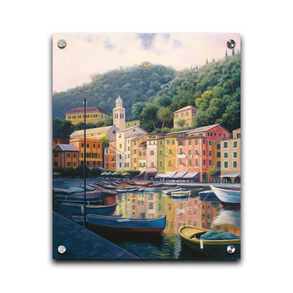 A painting of the colorful fishing town of Portofino. Many small boats are docked in the waters in the foreground, and the steep hills in the background are lush with trees. Printed on acrylic.