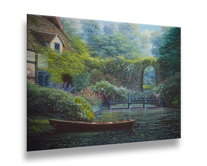 A painting of a canoe docked in a river covered in lily pads. A flower-covered bridge crosses the river, leading to a house coated in vines. A stone arched wall leads to another section of the garden in the background. Printed on metal.