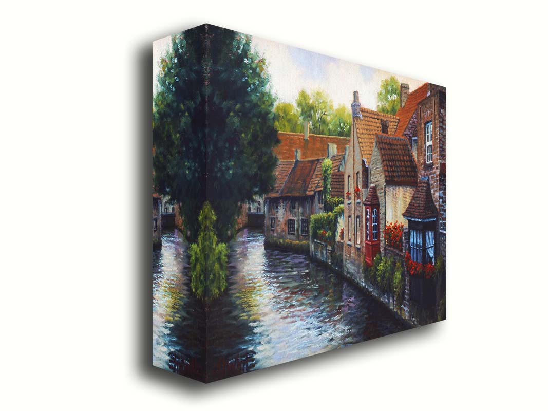 A painting of the Bruges Canal in Belgium, lined by brick homes with red and brown tlie roofs. Red flowers and a red bay window pop in the scene. Printed on canvas.