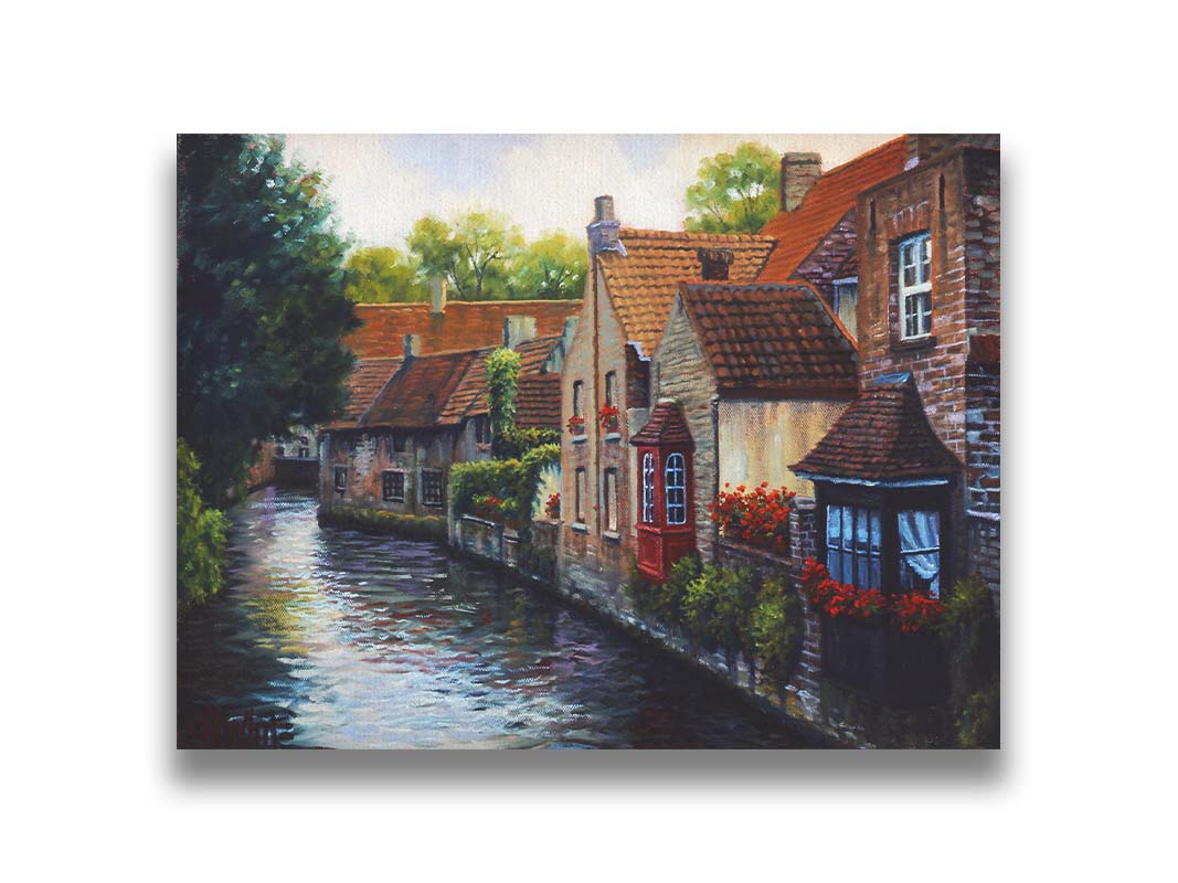 A painting of the Bruges Canal in Belgium, lined by brick homes with red and brown tlie roofs. Red flowers and a red bay window pop in the scene. Printed on canvas.