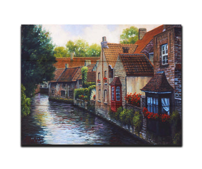 A painting of the Bruges Canal in Belgium, lined by brick homes with red and brown tlie roofs. Red flowers and a red bay window pop in the scene. Printed on a box board.