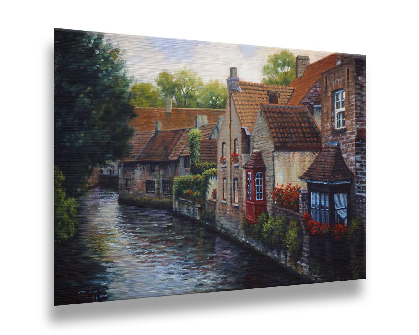 A painting of the Bruges Canal in Belgium, lined by brick homes with red and brown tlie roofs. Red flowers and a red bay window pop in the scene. Printed on metal.