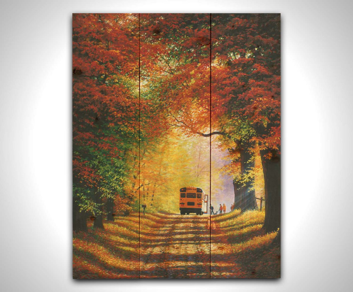 A painting of a narrow road trailing through an autumn forest, where a school bus has stopped to pick up children for school in golden morning light. Printed on a wood pallet.