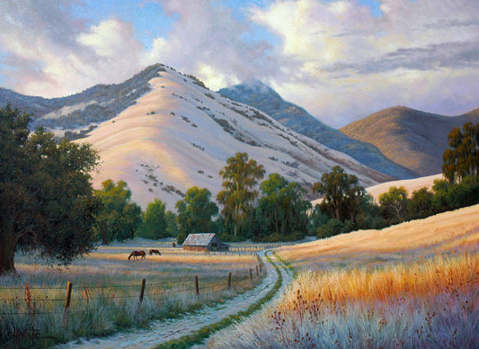 A painting of the volcanic hills of the Santa Ynez mountains from the perspective of the valley below. Clouds cast blue shadows between the light on the golden grasses of a field where horses graze. The mountain range reaches up through low clouds in the distance.