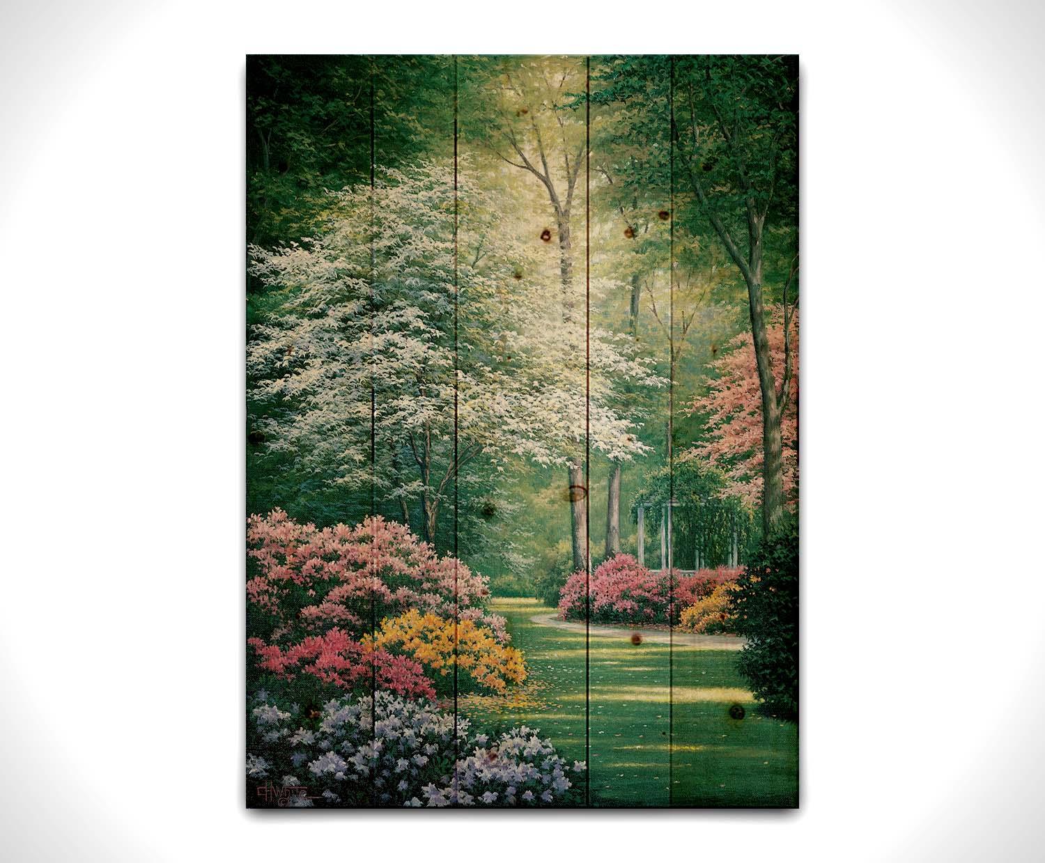 A painting of a vibrant garden, featuring a white gazebo. Flowering shrubs in an array of colors line the grassy path. Printed on a wood pallet.