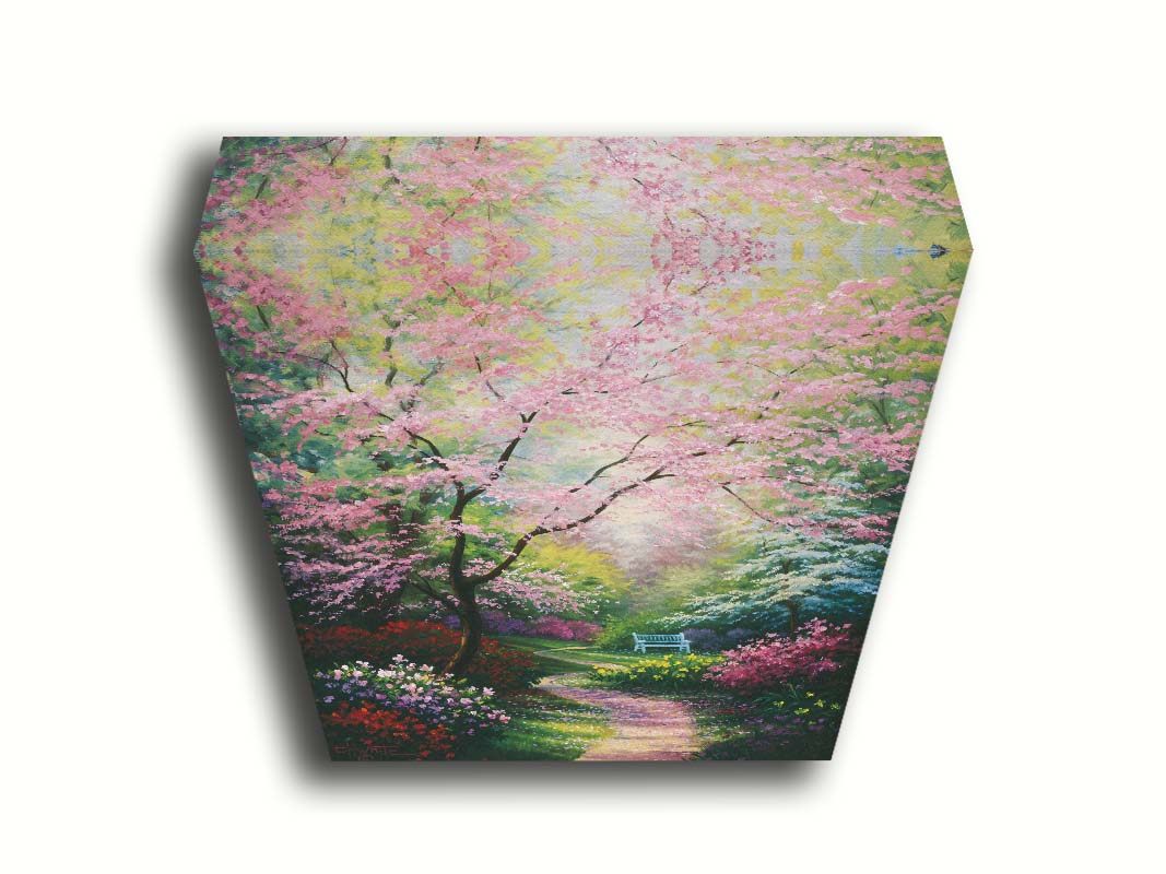 A painting of a garden in spring, with pink, red, and white blossoms on the bushes and trees. Pink petals fall from a tree by the narrow path, piling on the ground. A park bench can be seen in the distance. Printed on canvas.