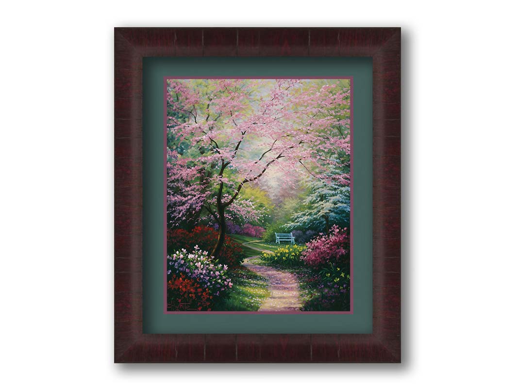 A painting of a garden in spring, with pink, red, and white blossoms on the bushes and trees. Pink petals fall from a tree by the narrow path, piling on the ground. A park bench can be seen in the distance. Printed on paper, matted, and framed.