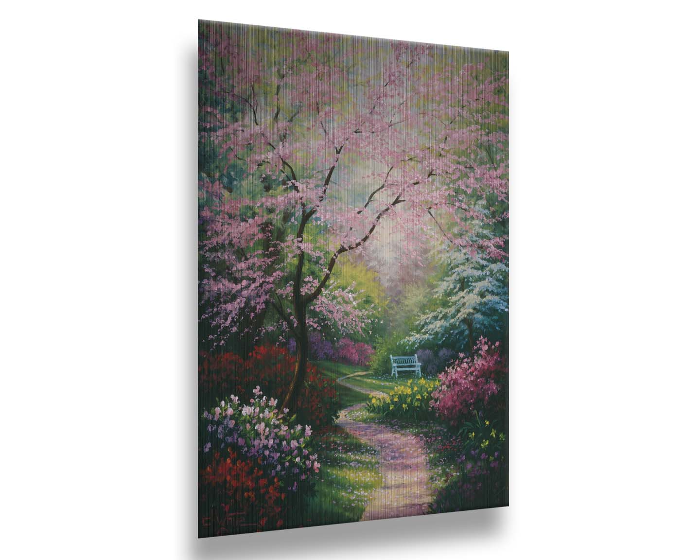 A painting of a garden in spring, with pink, red, and white blossoms on the bushes and trees. Pink petals fall from a tree by the narrow path, piling on the ground. A park bench can be seen in the distance. Printed on metal.