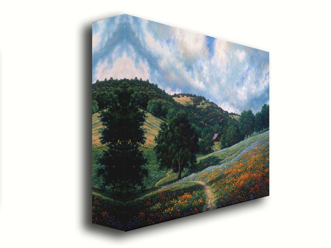 A painting of a hillside meadow of orange and blue flowers. A thin dirt path cuts through the meadow, leading to an old barn in the distance. Printed on canvas.