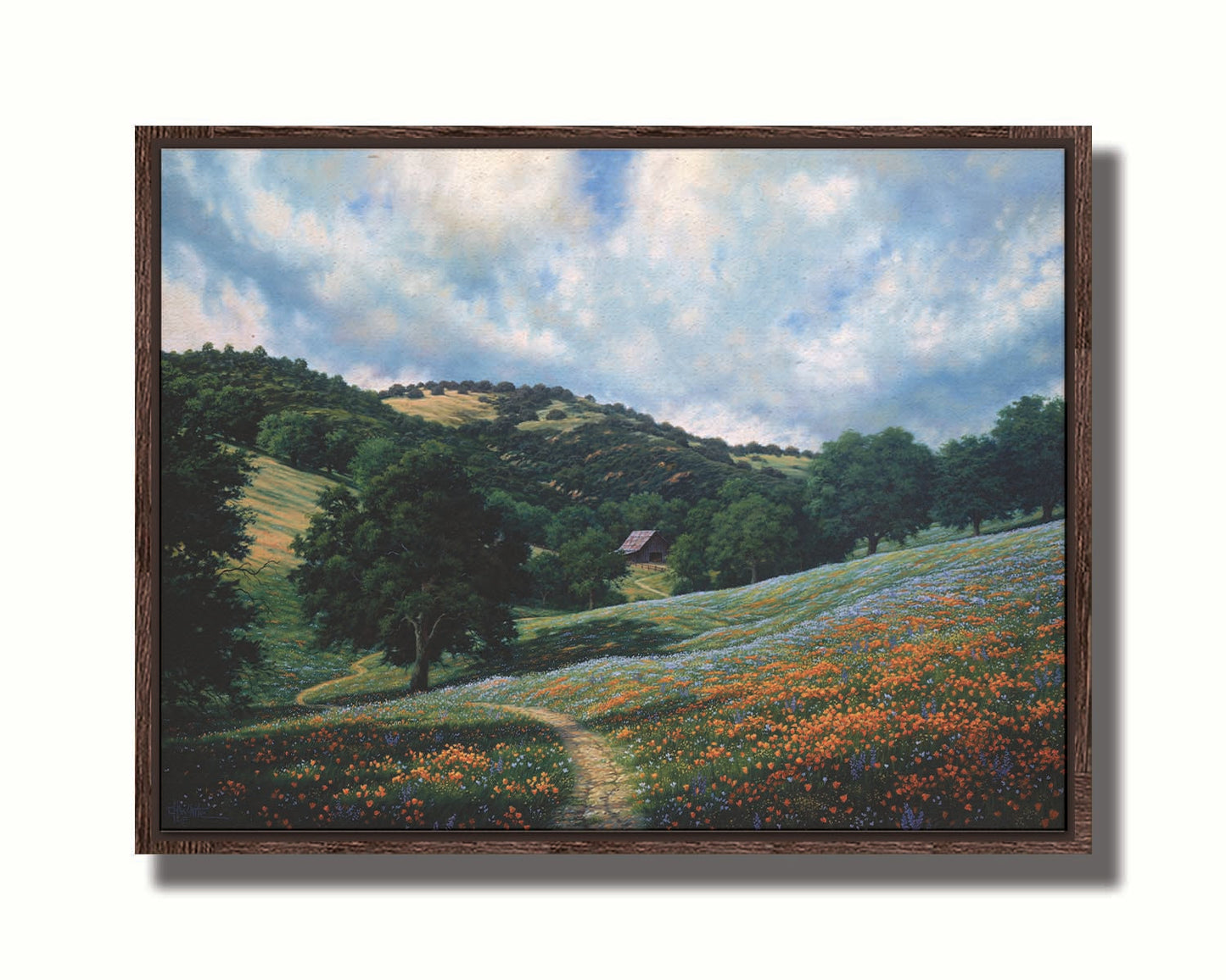 A painting of a hillside meadow of orange and blue flowers. A thin dirt path cuts through the meadow, leading to an old barn in the distance. Printed on canvas in a float frame.