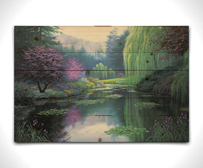 A painting of a tranquil lake, reflecting the greens, pinks, purples, and blues of the spring plant growth. Printed on a wood pallet.