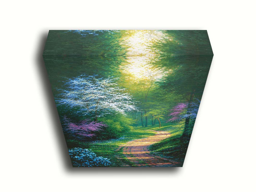 A painting of a dirt path through a wooded area during spring. Trees lining the road bloom in pink and white. Small yellow flowers dot the grass around the path. Printed on canvas.