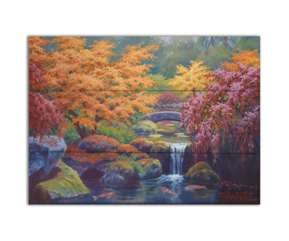 A painting of a garden with red, orange, and green trees. A stone bridge crosses a stream, which runs as a waterfalli into a pond of koi carp. Printed on a box board.