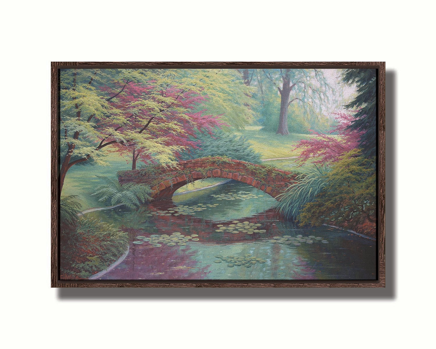 A painting of a red stone bridge crossing a river of lily pads. Red and green trees, grasses, and ferns surround it. Printed on canvas in a float frame.