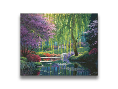 A painting of a garden pont, reflecting the surrounding scenery. Trees blossoming in pink grow with willows alonside the pond, as well as bushes of flowers in pink, red, yellow, white, and purple. Deer graze on the grass in the background, in a clearing with a white bench. Printed on canvas.