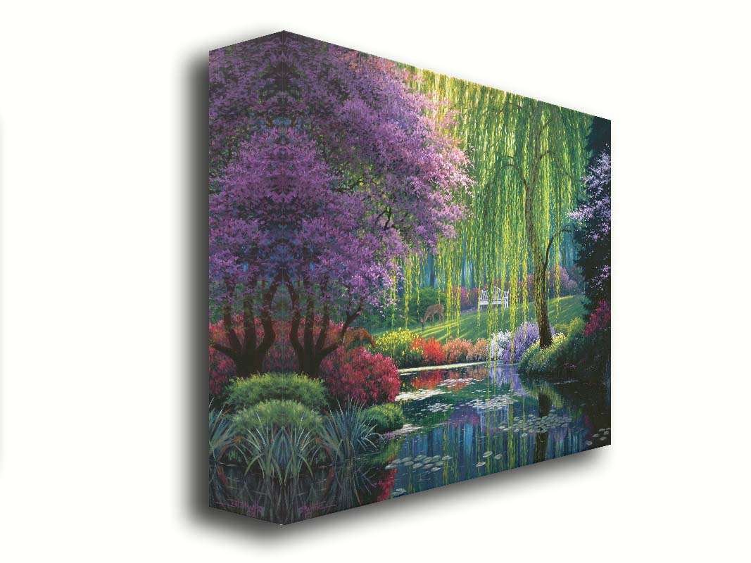 A painting of a garden pont, reflecting the surrounding scenery. Trees blossoming in pink grow with willows alonside the pond, as well as bushes of flowers in pink, red, yellow, white, and purple. Deer graze on the grass in the background, in a clearing with a white bench. Printed on canvas.