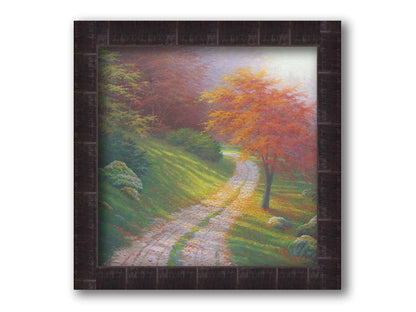 A painting of a gravel road winding around a hill between autumn trees. Printed on canvas and framed.