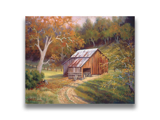 A painting of a dirt road near a forest, leading toward a rustic old barn. The leaves of the trees are turning colors for fall. Printed on canvas.