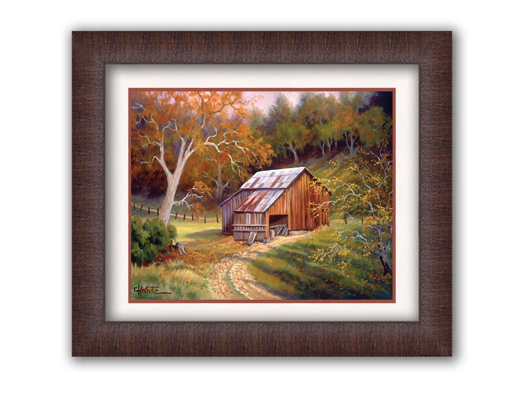 A painting of a dirt road near a forest, leading toward a rustic old barn. The leaves of the trees are turning colors for fall. Printed on paper, matted, and framed.