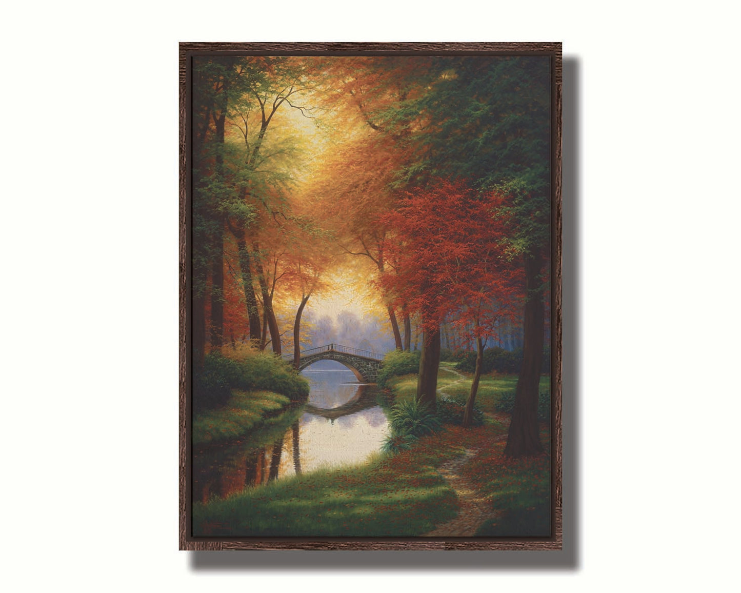 A painting of a path through a forested park in autumn, running alongside a stream to a bridge. Printed on canvas in a float frame.