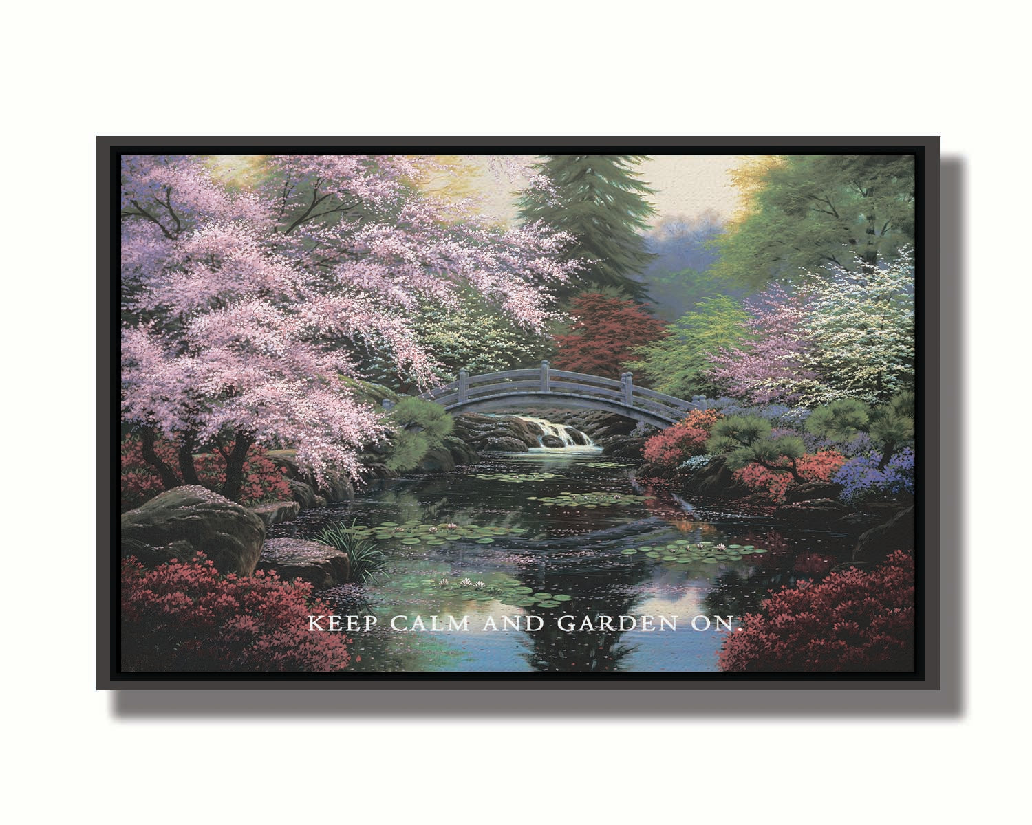 A painting of a tranquil pond surrounded by pink, red, and green flowered trees and shrubs. Lilly pads and fallen pink blossoms float on the water, which is crossed by a wooden bridge.A painting of a tranquil pond surrounded by pink, red, and green flowered trees and shrubs. Lilly pads and fallen pink blossoms float on the water, which is crossed by a wooden bridge. The quote "Keep Calm and Garden On" is overlayed across the bottom. Printed on canvas in a float frame.