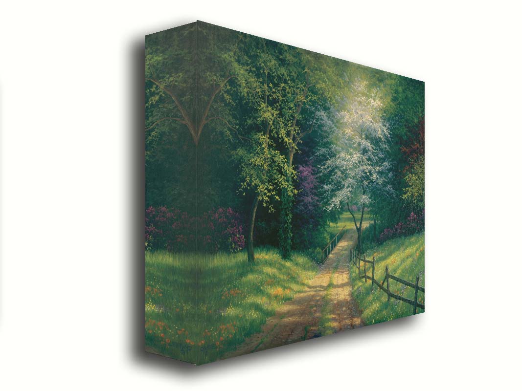 A painting of the view down a dirt road, surrounded by grass, wildflowers, and the colorful trees of spring. Light peeks through the branches, highlighting the road and connecting bridge. Printed on canvas.