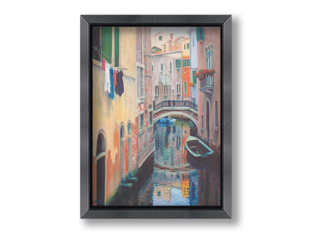 A painting of the alleyway canals of Venice, with boats floating on the water. Printed on canvas and framed.