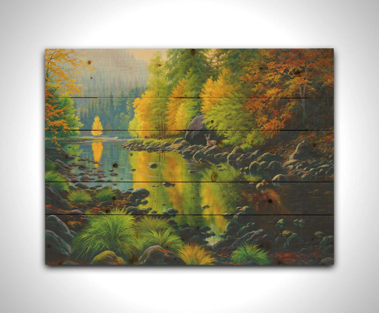 A painting of the Merced River in California. The bright greens and yellows of the forest trees are reflecting beautifully off the water. A few deer graze on the grasses alongside the river. Printed on a wood pallet.