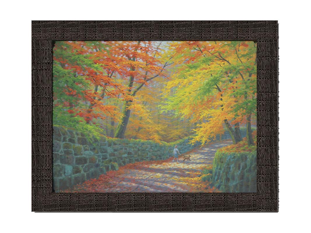 A painting of a stone road through a forest. It is bordered by stone walls on either side. The leaves of the trees are changing colors and dropping to the ground for fall. A person can be seen walking a leashed down further down the path. Printed on canvas and framed.