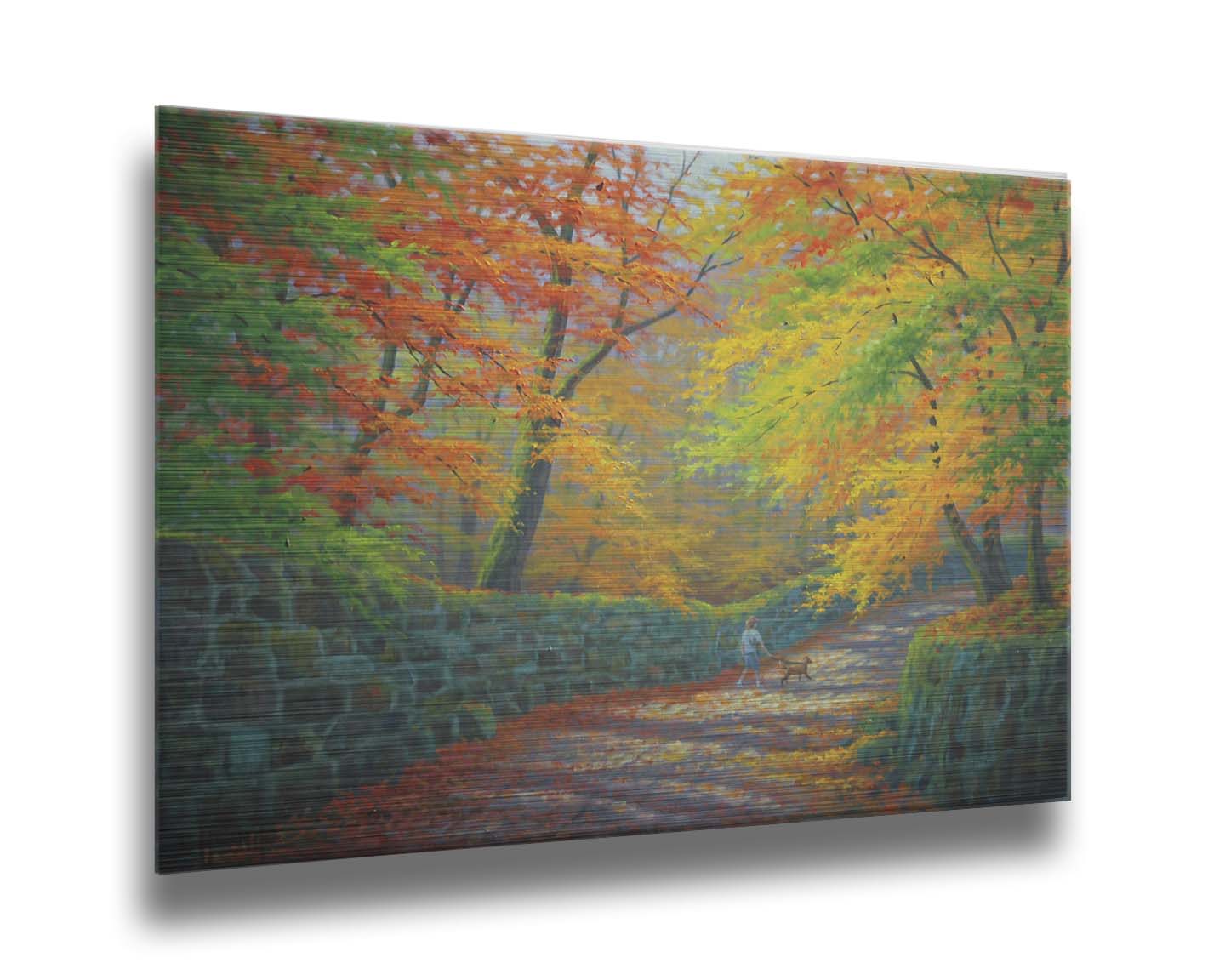 A painting of a stone road through a forest. It is bordered by stone walls on either side. The leaves of the trees are changing colors and dropping to the ground for fall. A person can be seen walking a leashed down further down the path. Printed on metal.